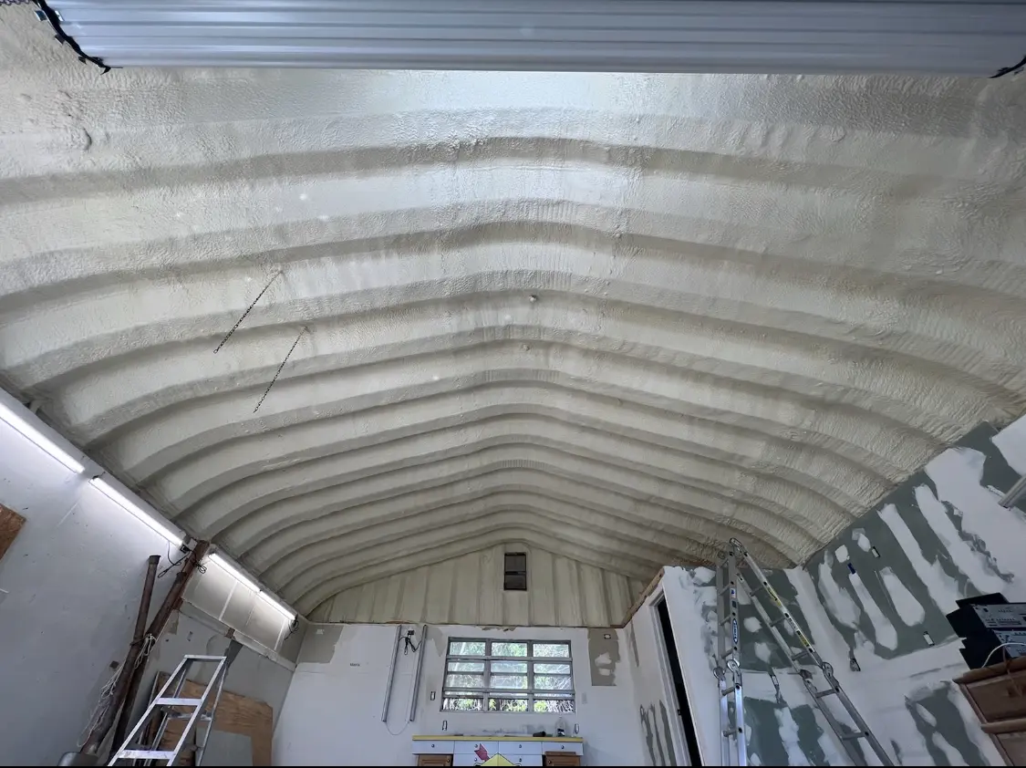 Spray polyurethane foam applied to the underside of a metal roof deck in Metropolis